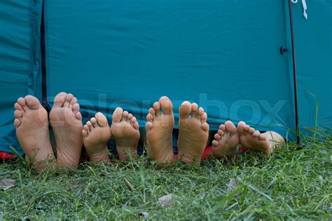 Four Peoples Feet Sticking Out Of Tent Stock Image Colourbox