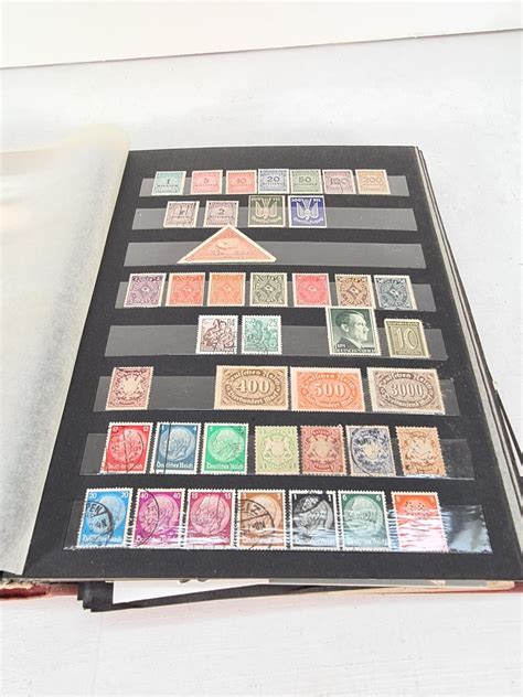 A Stamp Album Containing A Collection Of Various Stamps