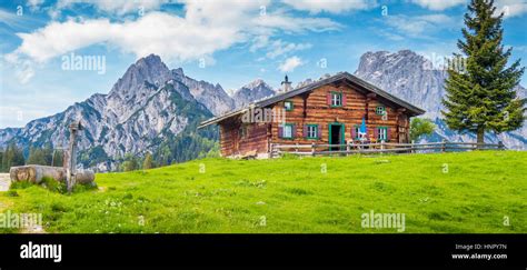 Panoramic View Of Idyllic Mountain Scenery In The Alps With Traditional