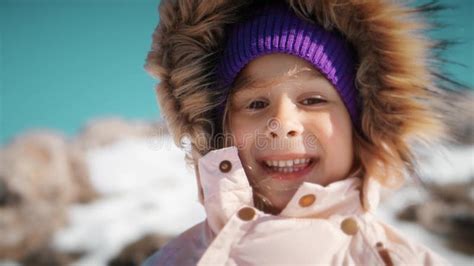 Close Up Portrait Of A Beautiful Little Girl Wearing Warm Clothes In