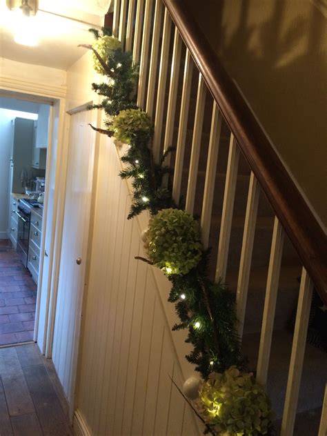 To dress your staircase for the holiday season, embellish a handmade garland of evergreen roping with additional greens and sprigs of pepperberries, then hang a couple of stockings with care. Stair wreath | Christmas decorations, Stairs, Decor