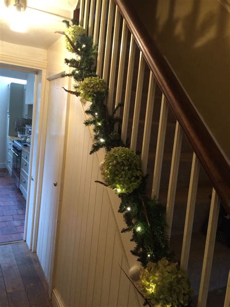 The natural direction of your gaze as you climb the stairs is toward the wall. Stair wreath | Stairs, Christmas decorations, Wreaths