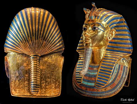 Two Gold And Blue Egyptian Masks Are Shown In Front Of A Black