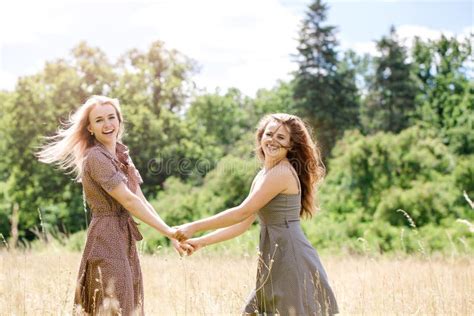 Two Young Beautiful Cheerful Girls Having Fun On The Meadow Stock Image Image Of Caucasian