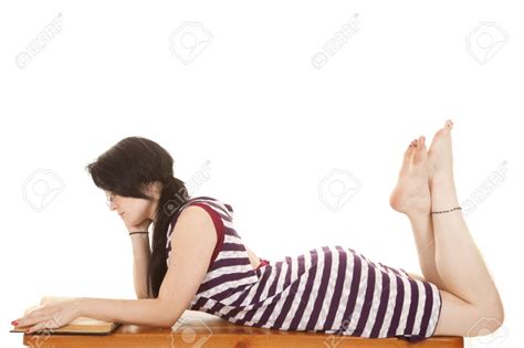 A Woman Laying On Her Stomach Reading With Her Bare Feet Up Body Reference Poses Woman