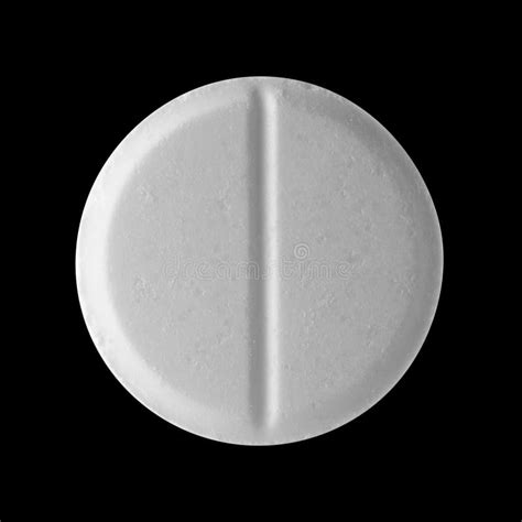White Round Pill On A Black Isolated Background Big Pill Close Up