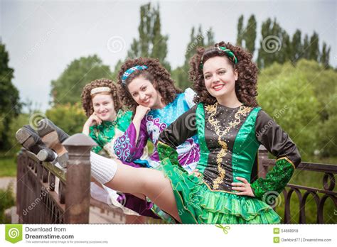Three Young Beautiful Girls In Irish Dance Dress And Wig Posing Stock