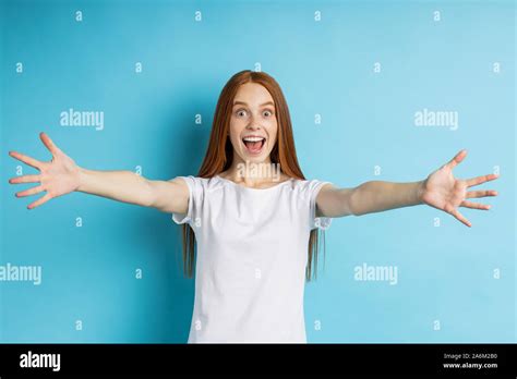 Come To Me Indoor Shot Of Overjoyed Happy Young Ginger Lady Giving Hug Stretching Both Hands