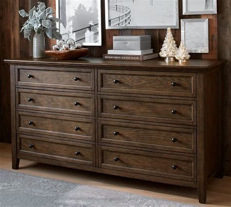 It's crafted from a blend of solid and engineered wood with a walnut wood grain tone, and features a beveled face and four flared legs for that. Hudson Extra-Wide Dresser | Pottery Barn