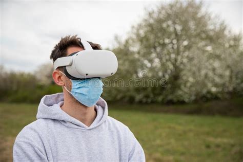 A Man Uses Virtual Reality Headset Outside Wearing A Surgical Mask Stock Image Image Of Game