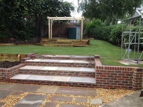 Brick Tiered Steps Complemented With Paving Slabs Surrounded By Pea