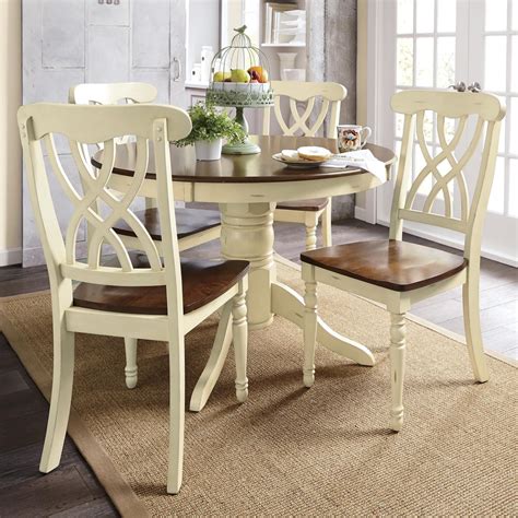 The four side chairs have a cross back design, adding flair to this stunning set. Round Dining Table & Set of 2 Chairs | Seventh Avenue