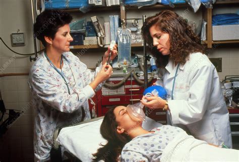 Emergency treatment: trauma team & female patient - Stock Image - M526/0124 - Science Photo Library