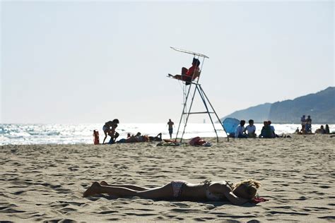 Teen Girl Sunbathing On Beach License Image Lookphotos