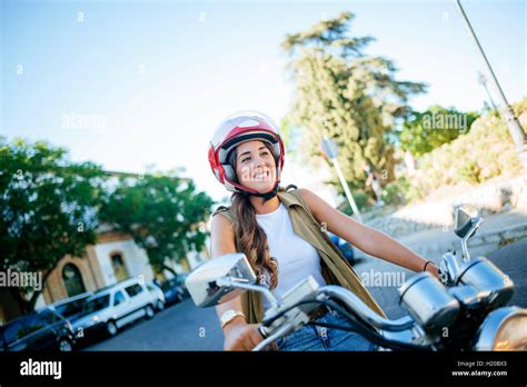 Happy Young Woman Riding Motorcycle Stock Photo Alamy