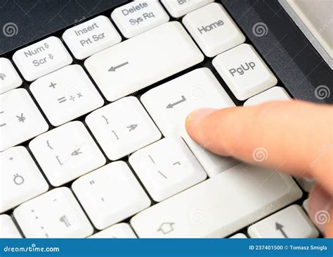 Man Pressing The Enter Key On A Simple Plain White Laptop Keyboard