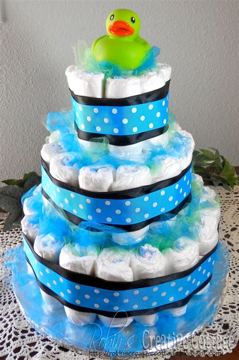 Some of the crafty diaper cakes include a tiered cake, tricycle, motorcycle, fondant style cake, a village and a cradle. Robin's Creative Cottage: Baby Shower Diaper Cake