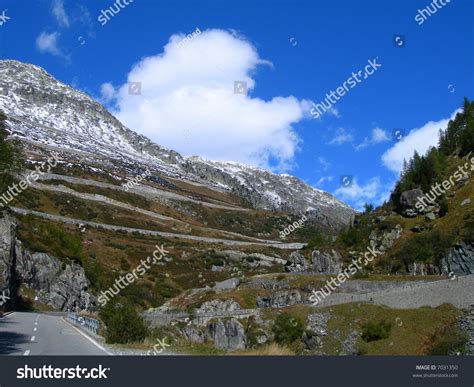 Swiss Alps Winding Road And A Hint Of Snow On Mountain Top