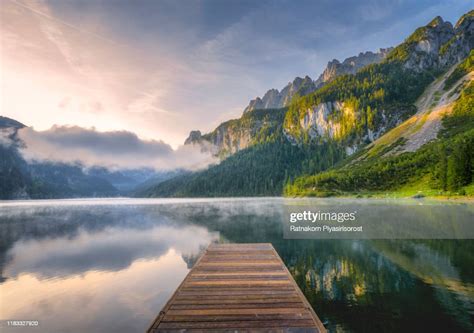 Fantastic Sunrise Scene With Fog Over Lake At Azure Alpine Lake