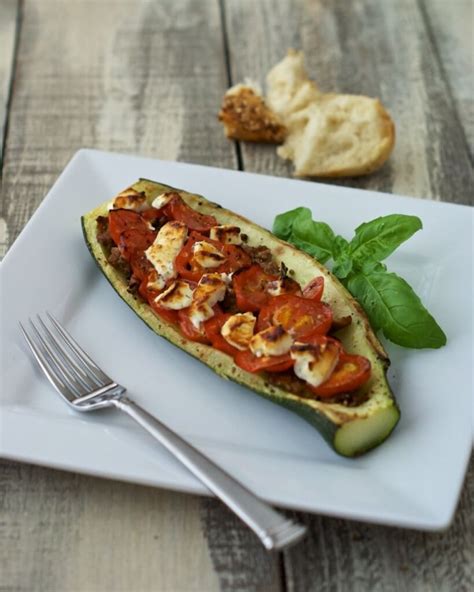 Looking for a light, healthy yet tasty summer meal? Stuffed Zucchini Boats with Sausage, Tomatoes, and Cheese ...