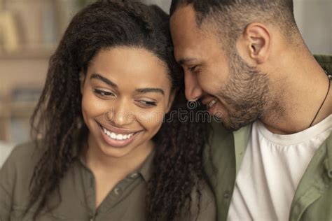 Loving African American Man And Woman Bonding At Home Embracing And