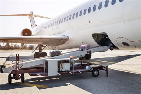 Loading Luggage On The Plane The Baggage On The Conveyor Belt To The