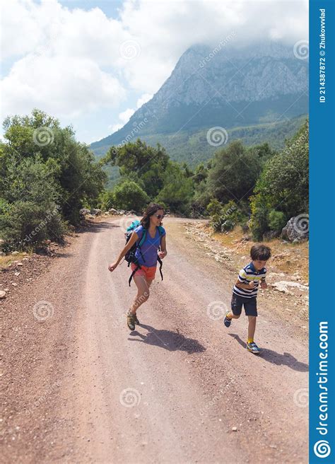 Boy Runs Away From Mom A Woman Travels With A Child Stock Photo