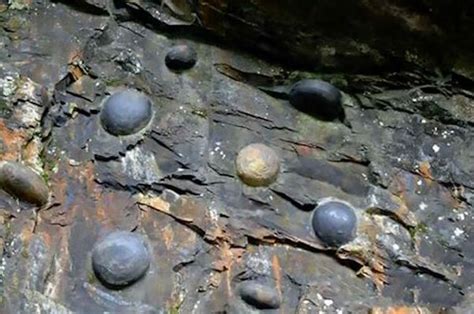 Whats Causing These Egg Shaped Rocks To Form On A Cliff In China