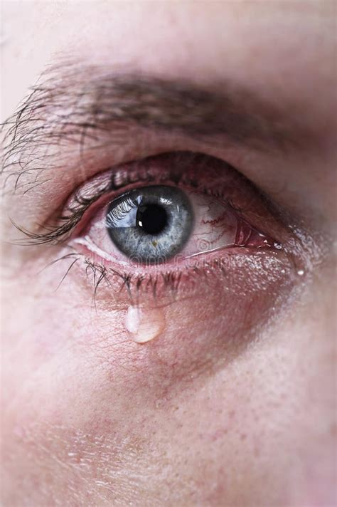 Close Up Of Blue Eye Of Man Crying In Tears Sad And Full Of Pain In