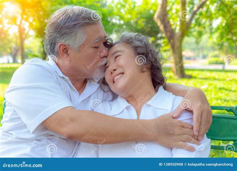 Romantic Older Couple Grandfather Or Senior Asian Husband Embracing