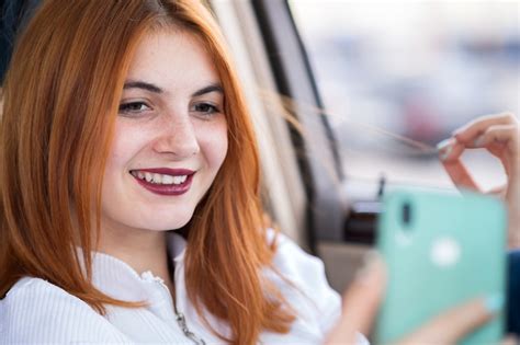 Premium Photo Young Redhead Woman Driver Taking Selfies With Her