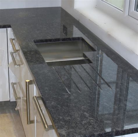 Steel grey granite is a dark gray granite with small specks of lighter gray. Steel Grey Granite worktops - Contemporary - manchester UK - by Cheshire Granite Worktops