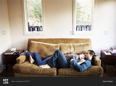 Check spelling or type a new query. Couple cuddling and sleeping on couch together stock photo ...