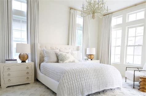 A romantic white bedroom decor with pink color. White Master Bedroom with Gold Lamps - Transitional - Bedroom