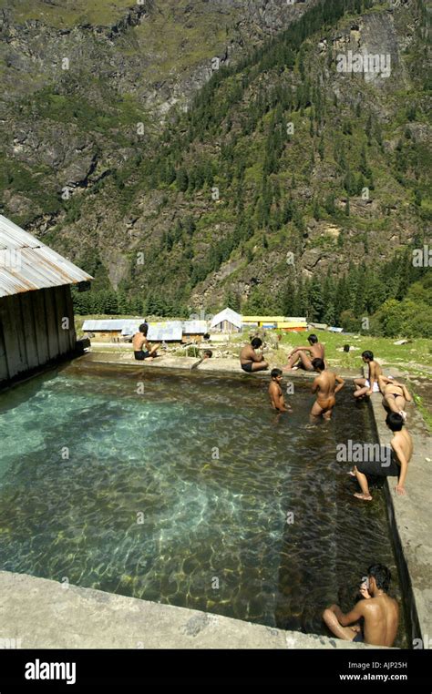 Many Men Bathing In Khirganga Hot Springs Pool Pond Parvati Valley India Himalaya Stock Photo