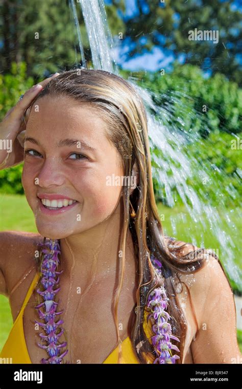 Beautiful Teenager In Yellow Bikini Taking A Shower Outdoors Stock