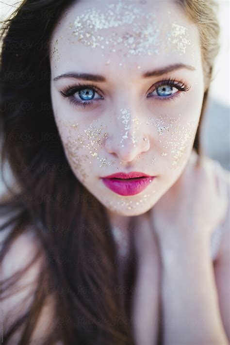 Portrait Of A Beautiful Young Woman With Blue Eyes And Glitter On Her Face Del Colaborador De