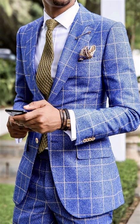 Long before the wedding begins, the groom, like the bride, mentally presents his wedding outfit. Blue and white plaid suit. #weddingideas #groom #groomsmen ...