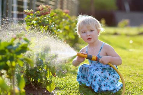 Little Girl Watering Plants In The Garden Stock Photo Image 44140838