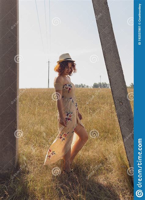 Red Haired Curly Haired Girl In A Summer Dress Posing In The Village