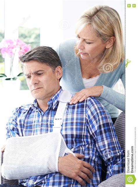 How much can i get for pain and suffering after an accident? Wife Comforting Husband Suffering With Arm Injury Stock ...