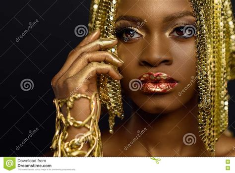 sexy african american female model with glossy makeup and golden glossy makeup hair