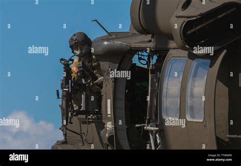 A Us Army Uh 60 Blackhawk Door Gunner Mans His Position During Red