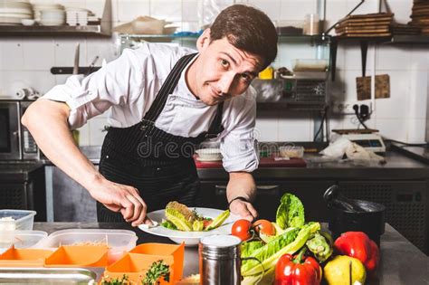 Professional Chef Cooking In The Kitchen Restaurant At The Hotel