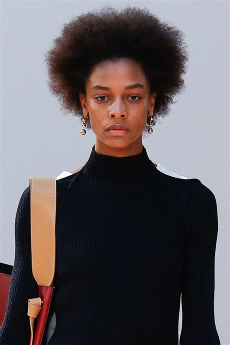Black swan necklace features matte black two swans holding a black crystal which is on a baroque frame. Afro Hair On The Catwalk