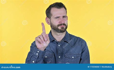 The Portrait Of Young Man Saying No By Finger Yellow Background Stock
