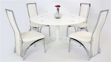 The pedestal base of this dining table showcases a geometric pattern and shape for maximum visual appeal. White Gloss Dining Table and 4 Chairs - Homegenies