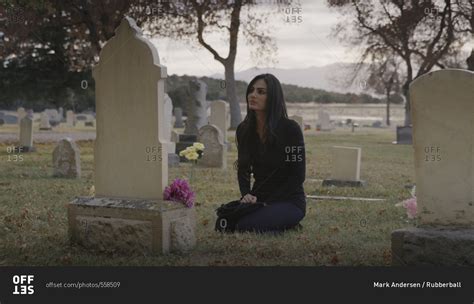 Sad Pensive Woman Sitting At Grave In Lonely Cemetery Stock Photo Offset