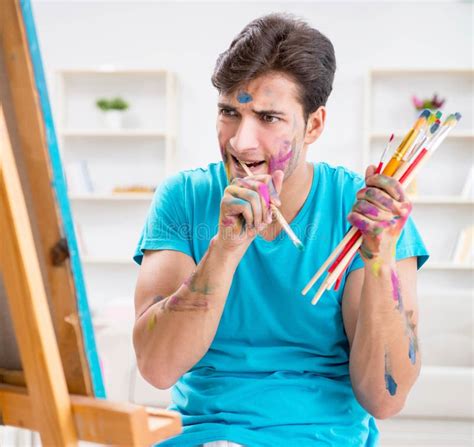 Young Funny Artist Working On New Painting In His Studio Stock Image