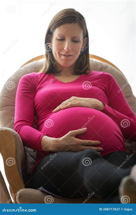 Pregnant Woman In Rocking Chair Touching Her Belly Stock Image Image